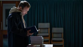 Andy (Stephen Graham) thumbing through a book at an Alcoholics Anonymous meeting in Boiling Point episode 2