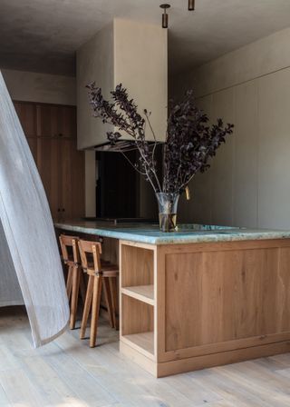 Green and white marble kitchen island counter top, wooden high chairs