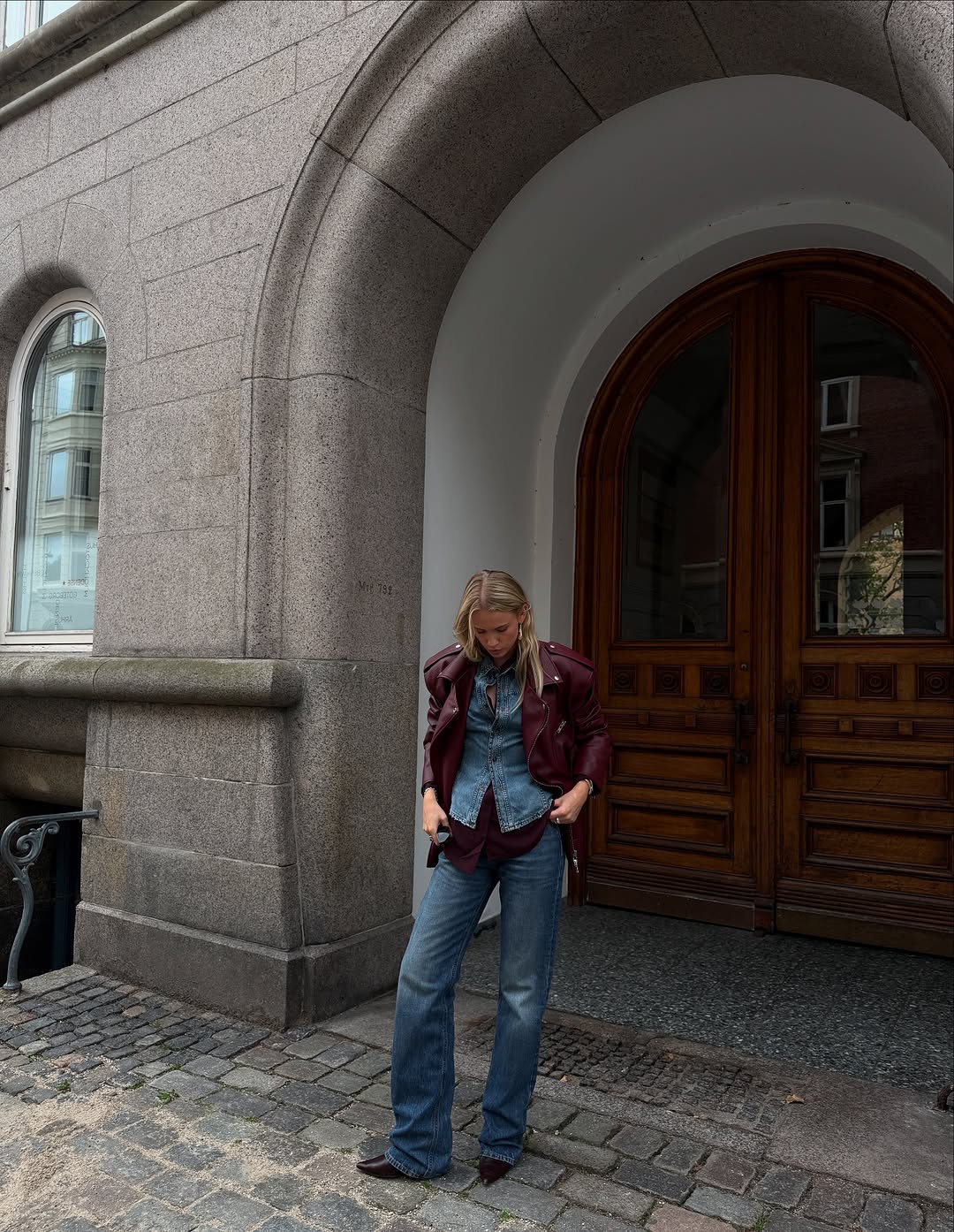 woman wearing dirty denim wash jeans fall denim trend 2025