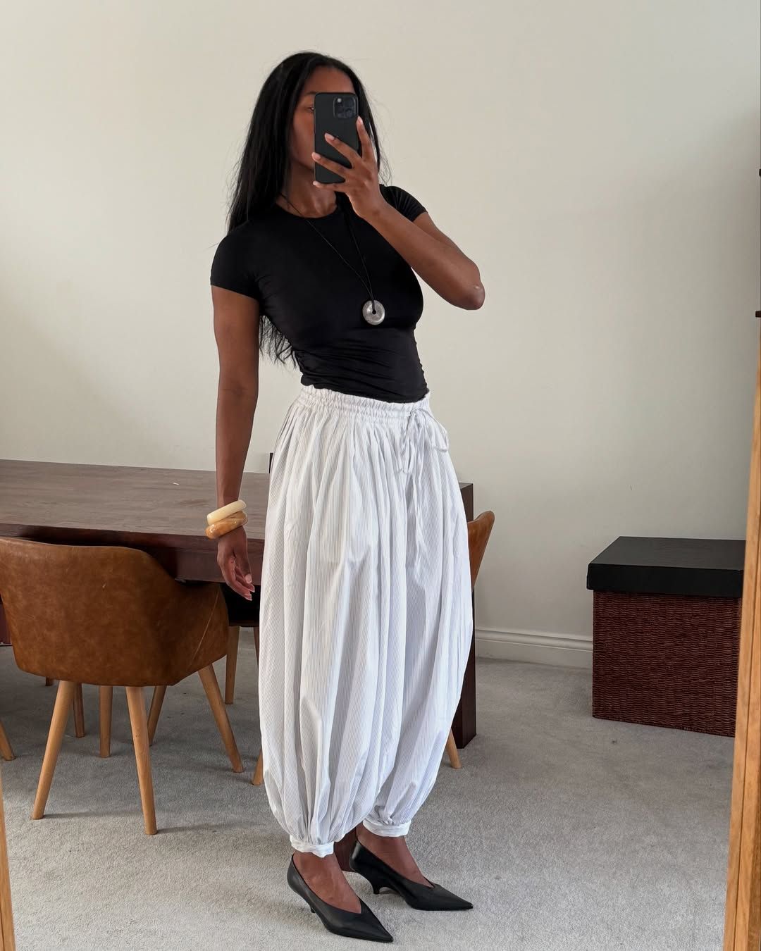 an influencer wearing white harem pants