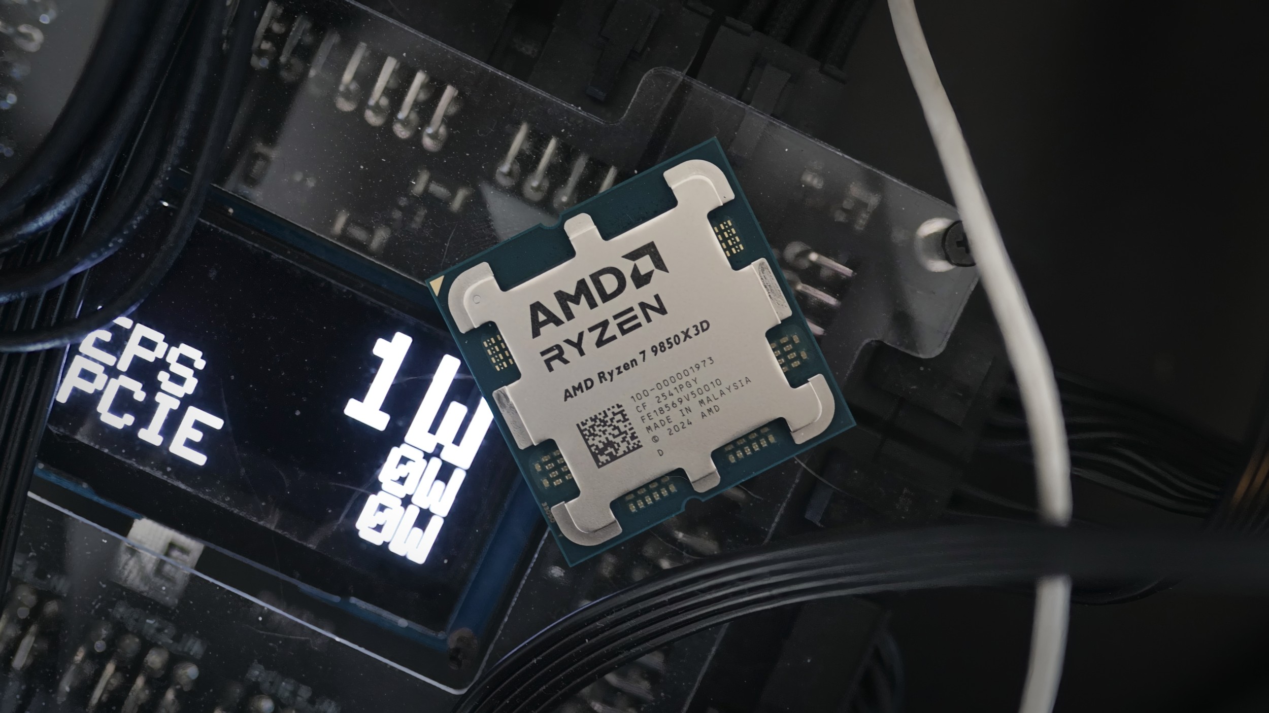 The AMD Ryzen 7 9850X3D CPU sitting on the PMD2 power tester.