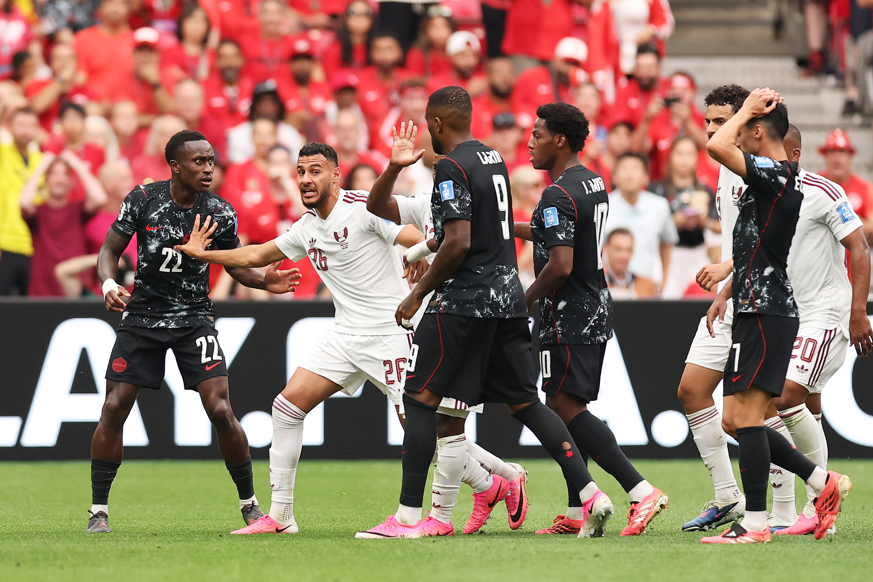 VANCOUVER, BRITISH COLUMBIA - JUNE 18: Players of Qatar and Canada argue Ismael Kone #8 of Canada is fouled by Assim Madibo #23 of Qatar during the FIFA World Cup 2026 Group B match between Canada and Qatar at BC Place Vancouver on June 18, 2026 in Vancouver, British Columbia. (Photo by Fran Santiago/Getty Images)
