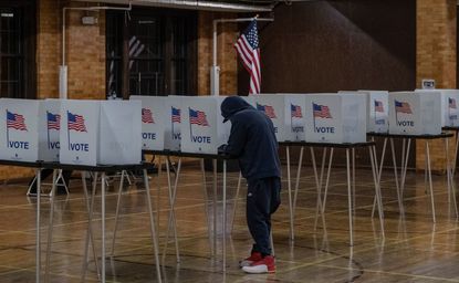 A man votes in Michigan.