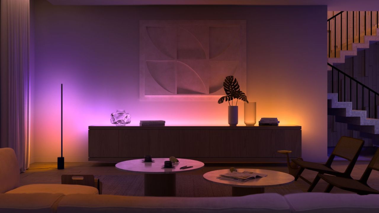 Philips Hue Play Gradient Signet light strip in a living room along a sideboard