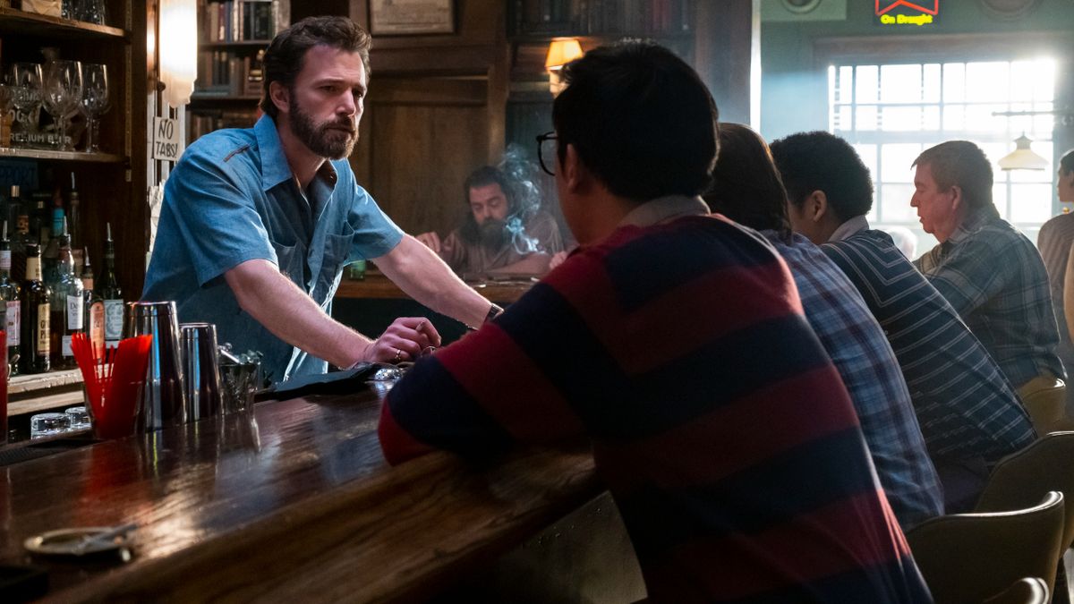 Ben Affleck stands behind the bar, looking concerned, in The Tender Bar.