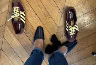 @annelauremais trying on Adidas SL72 sneakers and black mules on a wood floor.