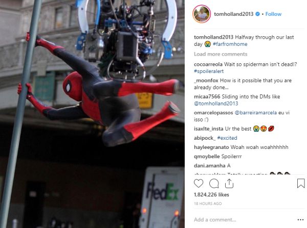 Spider-Man swinging on a bar, in set photo image