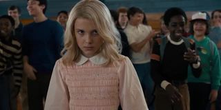 Stranger Things' Eleven dressed in a pink dress and wig disguise