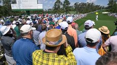 Patrons watch the first round of The Masters