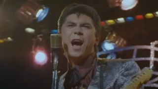 Ritchie Valens singing on stage in La Bamba