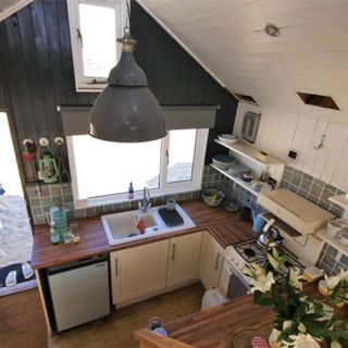 beach hut with kitchen with wooden flooring