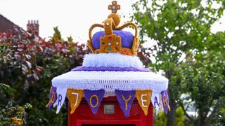 A crochet decorated post box with a crown on celebrating the Queen’s Platinum Jubilee is seen on May 19, 2022 in Weymouth, United Kingdom