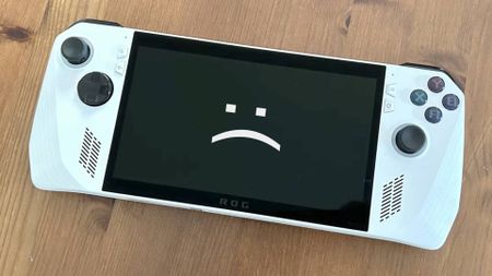 Asus ROG Ally with sad text face on screen.