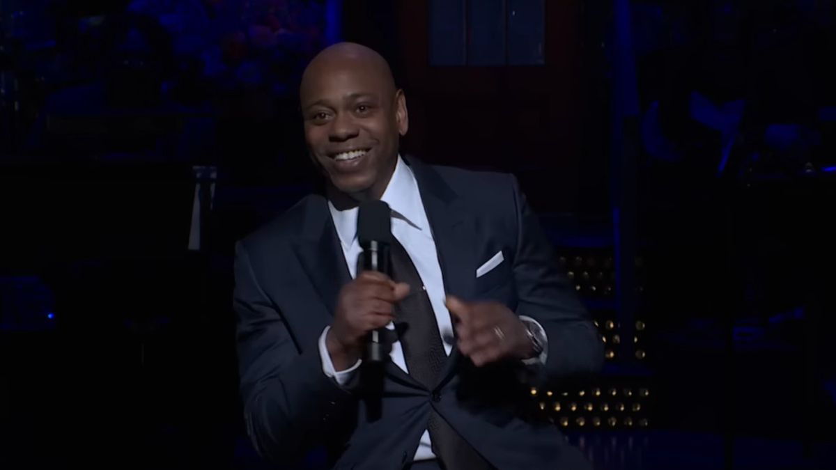 Dave Chappelle laughs during his opening monologue on SNL.