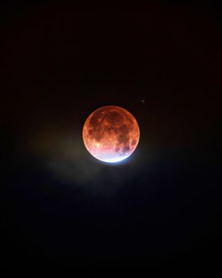 A small sliver of partially the eclipsed moon is slowly taken over by Earth's red shadow in this photo of the total lunar eclipse on Jan. 31, 2018. Astrophotographer Jaxson Pohlman captured this photo of the partial phase of the eclipse from Wichita, Kansas.
