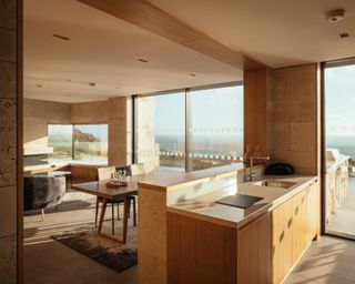 A contemporary apartment designed using wood and concrete with mid-century modern furniture and sea views.