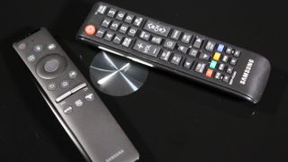 The Samsung Q70 QLED TV remote against a black background