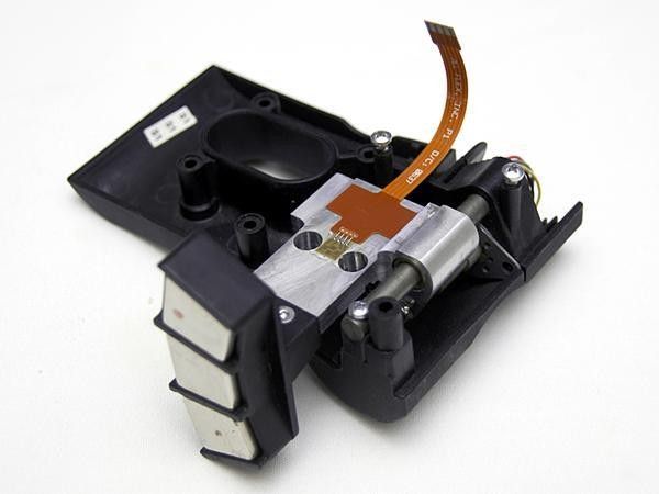 The linear stepper motor simply alters the distance from the magnets to the conductive zinc flywheel, thus altering the strength of the magnetic field and resistance.