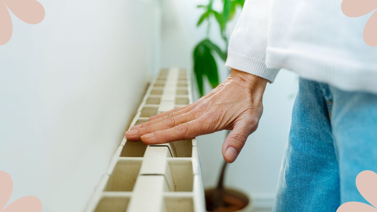 Heating hack that will save you £100+ - woman turning on radiator and feeling it for warmth