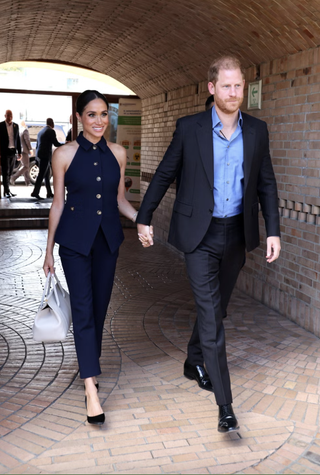 Meghan Markle and Prince Harry enter a building in Colombia wearing coordinating suits