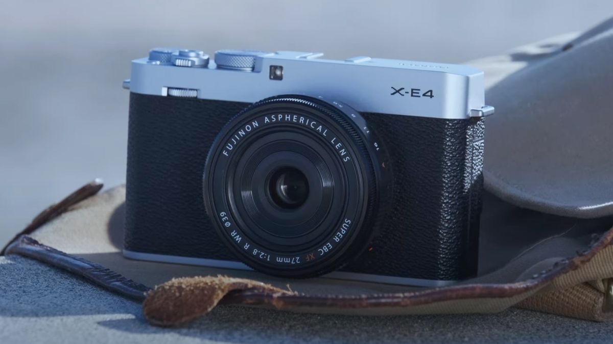 The Fujifilm X-E4 camera sitting outside on a bag