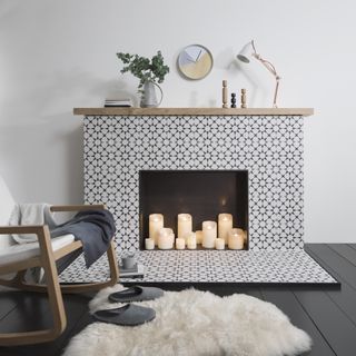 Empty fireplace with candles and tiled surround