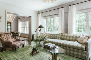 living room with green sofa and arm chair