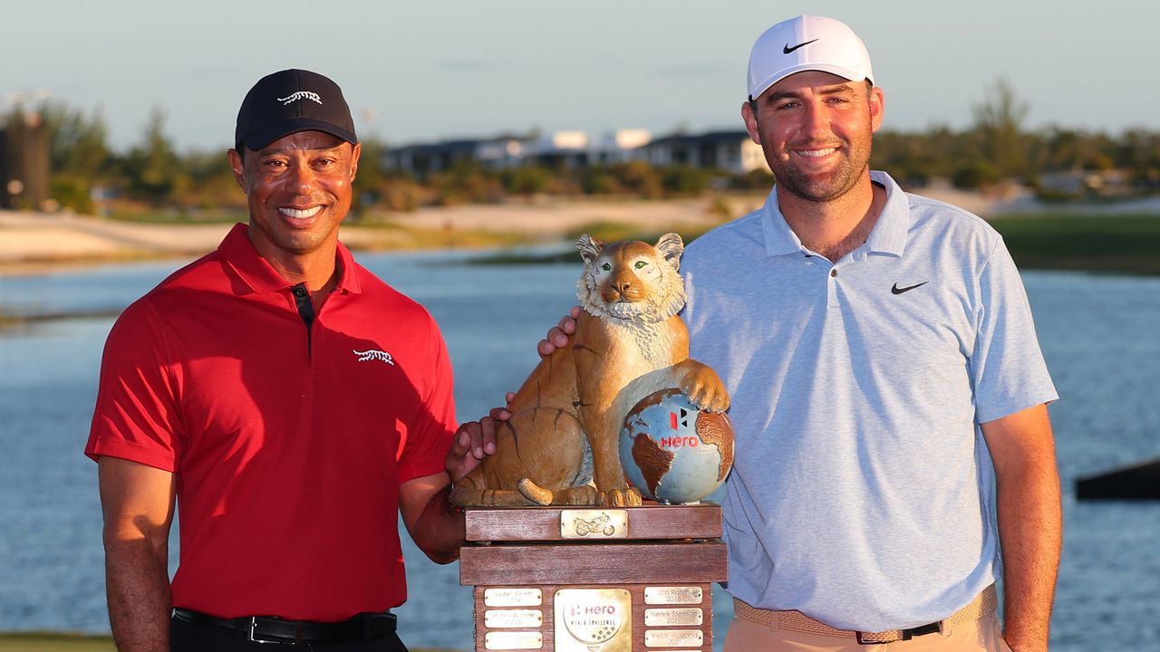 Tiger Woods and Scottie Scheffler pose with the Hero World Challenge trophy