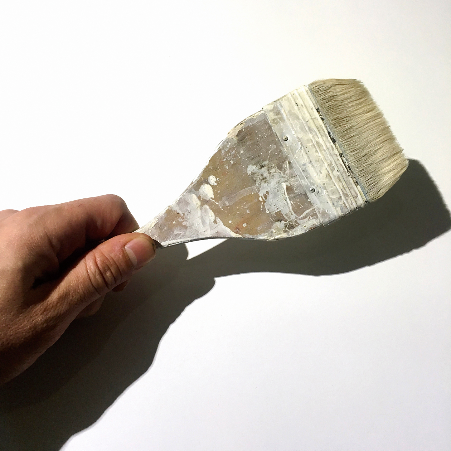 Picture of hand holding paintbrush