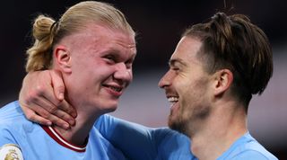 Erling Haaland and Jack Grealish celebrate their team's win in the Premier League match between Arsenal and Manchester City at the Emirates Stadium on February 15, 2023 in London, England.