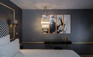 Hotel Snob room with hanging chandelier and grey wall