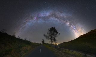 This night-sky photo by astrophotographer Miguel Claro reveals a lovely summer scene where the arc of the Milky Way galaxy is shining bright above Pampilhosa da Serra, in Dark Sky Aldeias de Xisto, Portugal.
