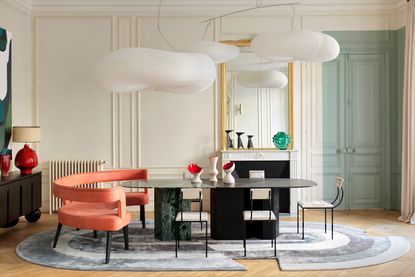 A dining room table with a rug underfoot