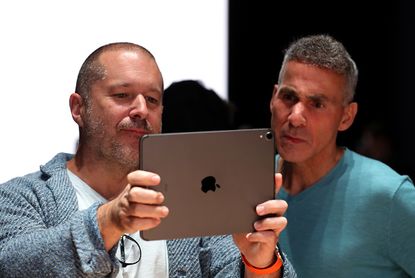 Jony Ive and Apple senior VP of hardware engineering Dan Riccio look at an iPad