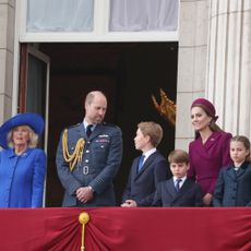 Queen Camilla, Prince William, Princess Kate, Prince George, Prince Louis and Princess Charlotte standing on the balcony of Buckingham Palace