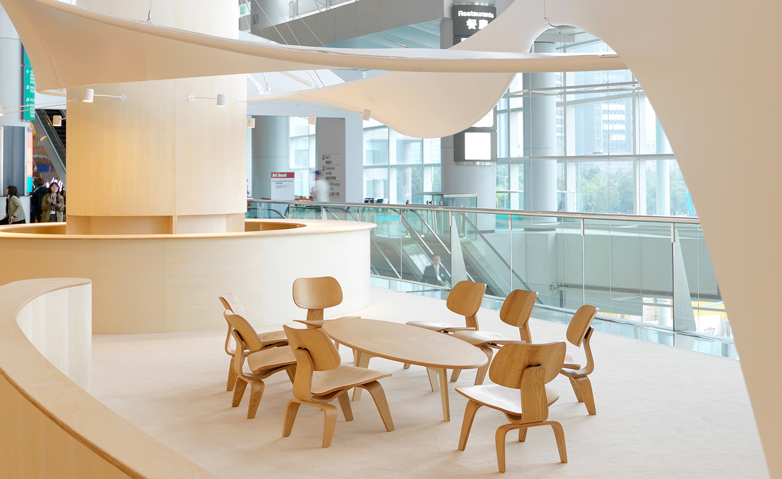 Dining area and lounge, glass fronted building, wooden table and chairs