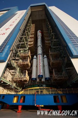 China's integrated Tiangong 1 spacecraft and Long March 2F rocket is slowly rolled out of the vehicle assembly building to its launch site.