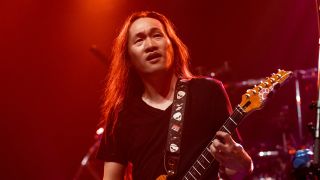 Herman Li playing on stage with Dragonforce
