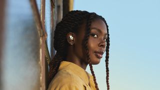 A woman wearing the beats studio buds in white