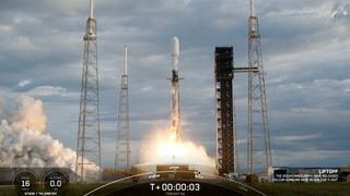 a black-and-white spacex falcon 9 rocket launches into a cloudy sky.