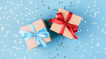 gifts wrapped in red and blue bows on sparkly blue background