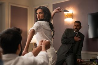 poorna jagannathan as lucky throwing a knife in a still from deli boys