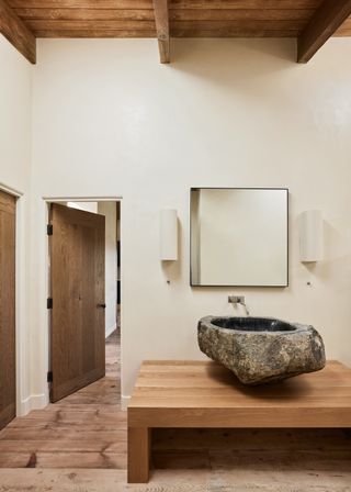 A bathroom with stone sink