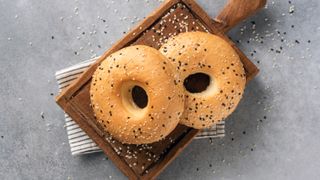 a photo of two white bagels on a chopping board