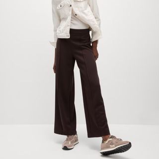 Flat lay cropped image of woman wearing brown trousers