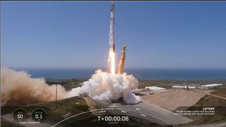 a rocket launches aganist a blue sky