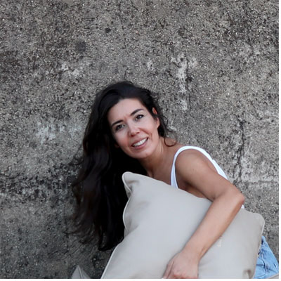 interior designer Miriam Prada holding a cushion