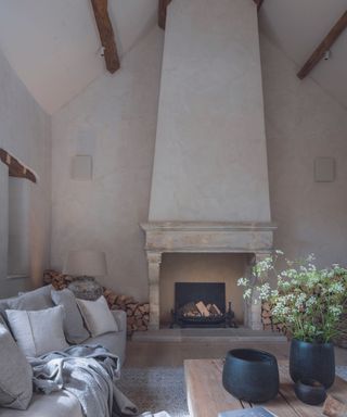 living space with fireplace and off white walls and exposed wooden beamed ceiling
