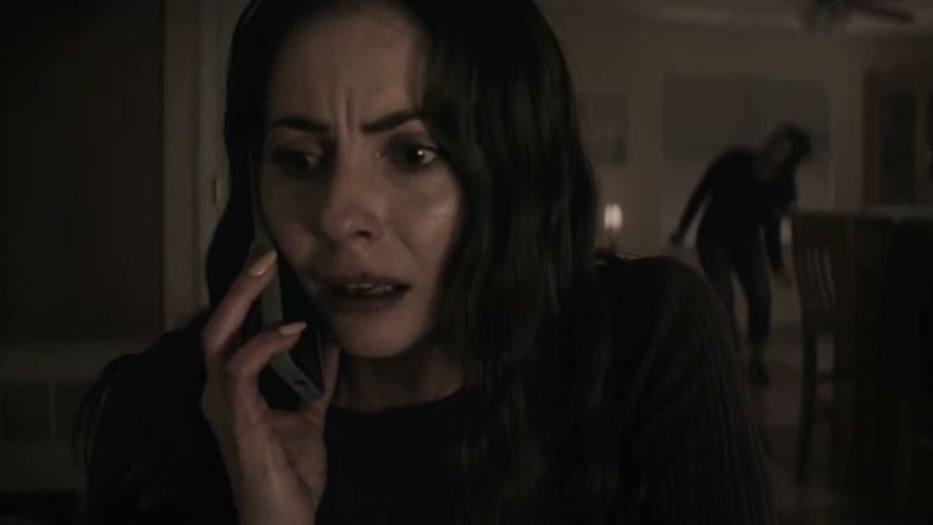 Willa Holland as Rebecca Owens on the phone while something lurks in the background behind her