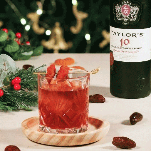 Old Fashioned cocktail and a bottle of Tawny Port
